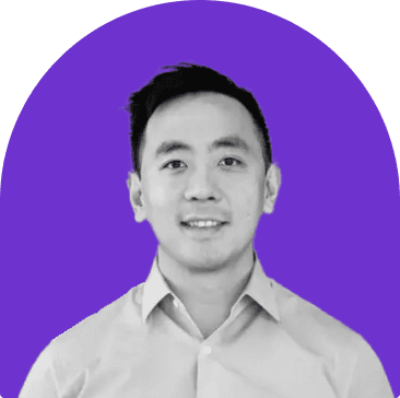 Black and white headshot of Wayne Ting, who is smiling and wears a white collared button up shirt. He has short black hair. The headshot is on a purple curved rectangle background.